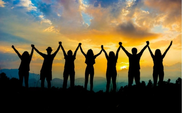 silhouette of people holding hands together